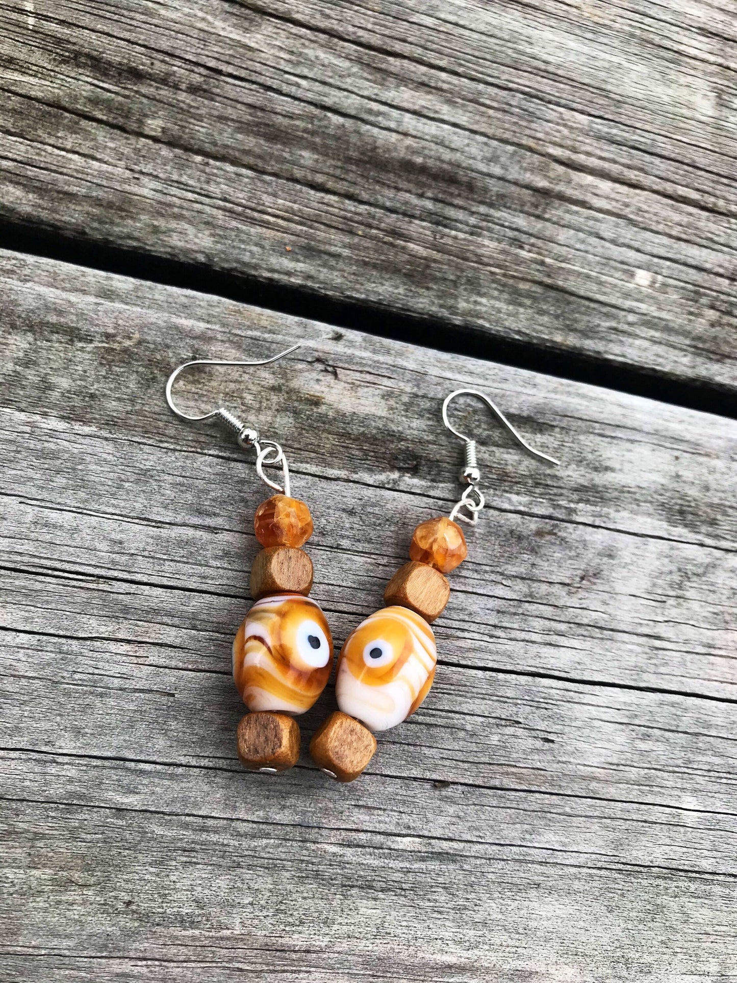 Trippy eye dangle earrings with glass and wood beads